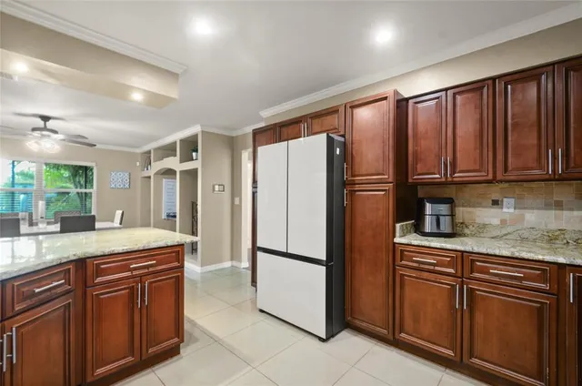 a kitchen with stainless steel appliances granite countertop a refrigerator and a sink