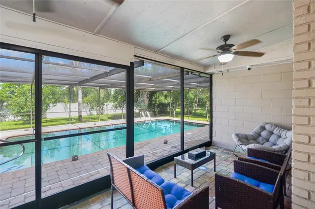 a living room with furniture and a floor to ceiling window