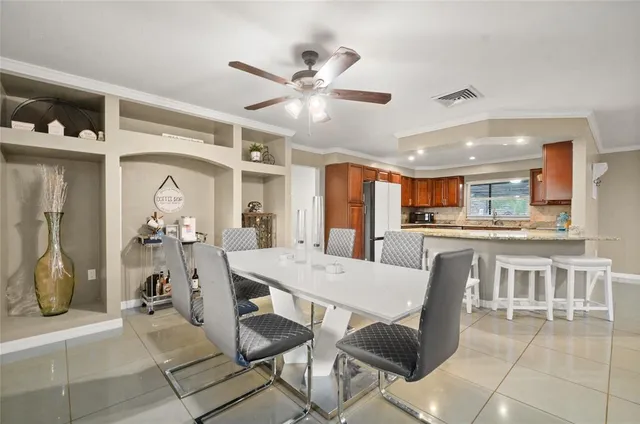 a view of a dining room with furniture and a kitchen