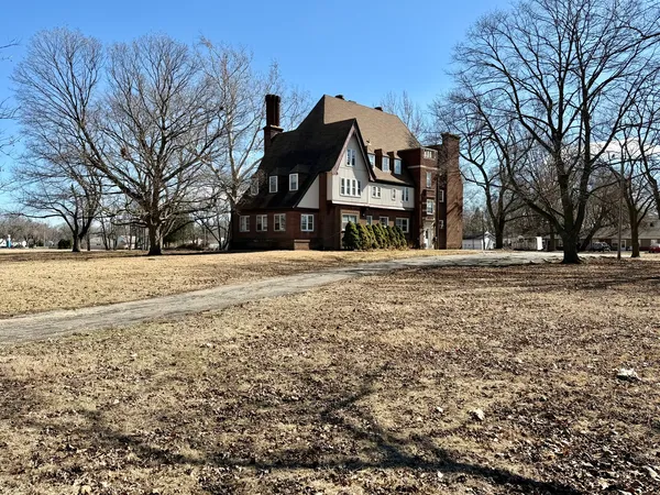 a front view of a building with a yard