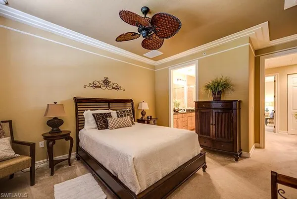 a bedroom with a bed and dresser with mirror