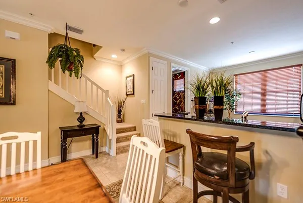 a dining room with furniture and a large window