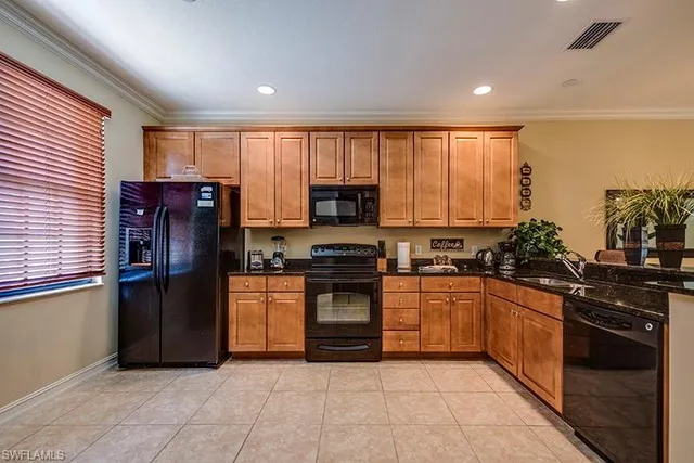 a kitchen with granite countertop stainless steel appliances and cabinets