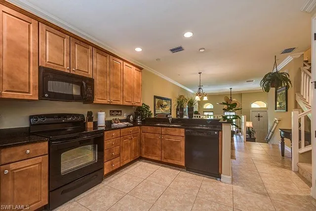 a kitchen with stainless steel appliances granite countertop a stove and cabinets