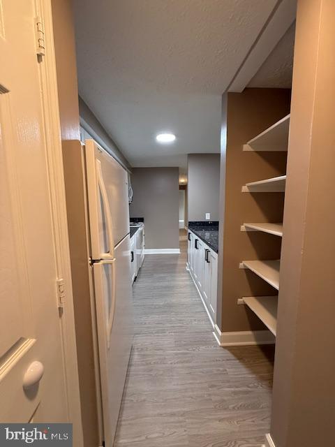 19513 Gunners Branch Road, Unit 514 Germantown, MD 20876 - Photo 6 of 42 a view of a kitchen with refrigerator and white cabinets