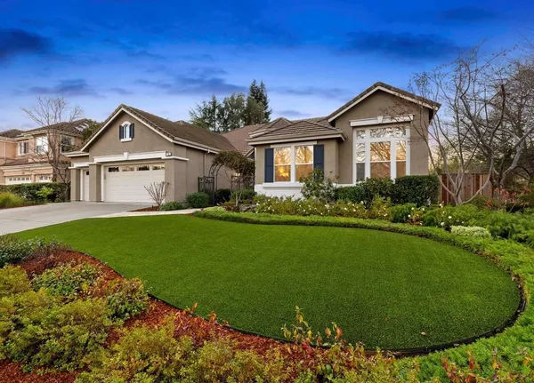 a front view of a house with garden