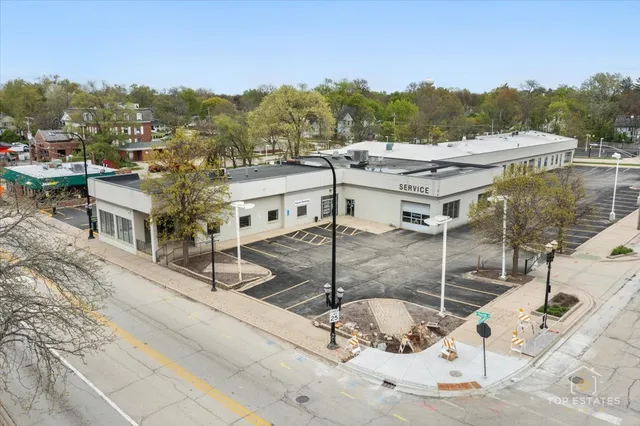 a large kitchen with kitchen island a counter top space a sink stainless steel appliances and cabinets