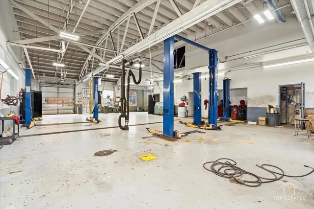 a kitchen with a table chairs refrigerator and cabinets