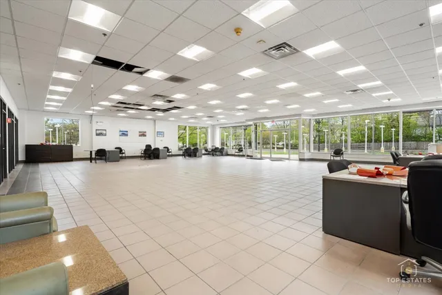 a kitchen with a table chairs and refrigerator