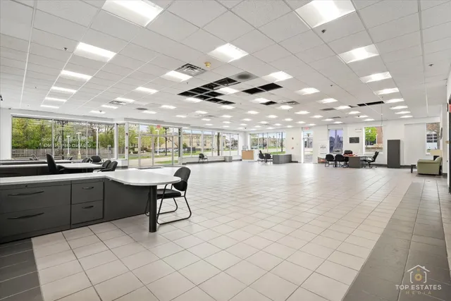 a view of a street with a bench and trees