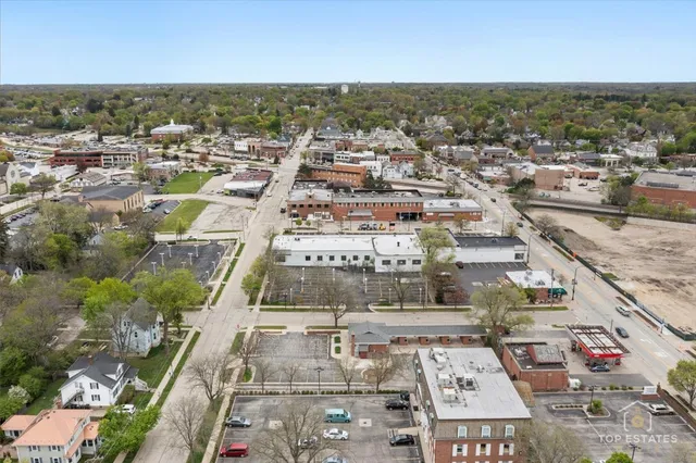 an aerial view of residential houses with city view