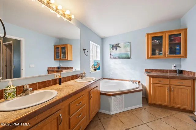a spacious bathroom with a granite countertop sink a toilet and a mirror