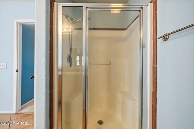 a living room with furniture a flat screen tv and a window