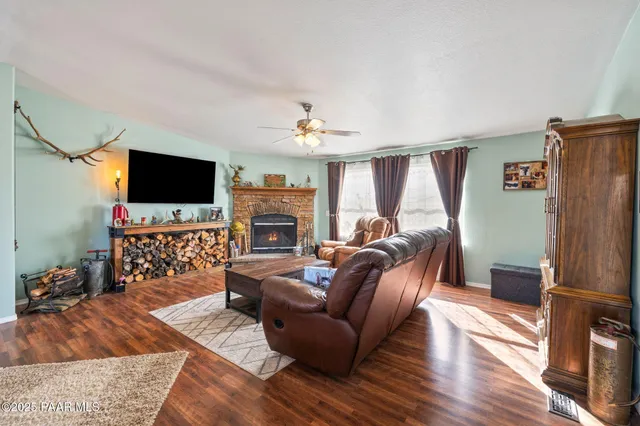 a living room with furniture and view of kitchen
