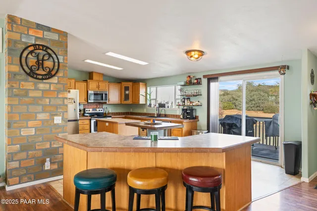a kitchen with stainless steel appliances granite countertop a stove and a refrigerator