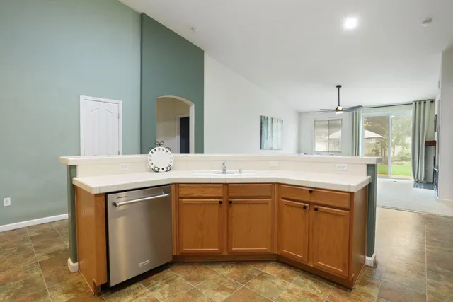a kitchen with a sink appliances and cabinets