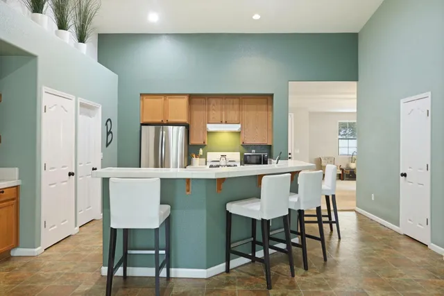 a large kitchen with kitchen island a large island in the center