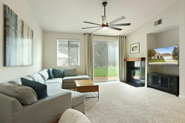 a living room with furniture and a view of kitchen