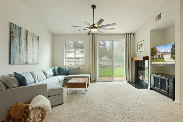 a large dining hall with stainless steel appliances kitchen island granite countertop furniture and a view of kitchen