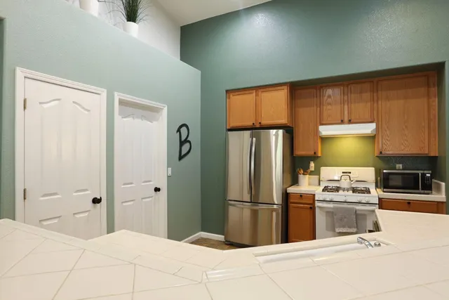 a bedroom with a bed and lamp on dresser