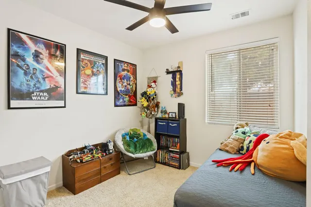 a spacious bedroom with a bed and a chandelier