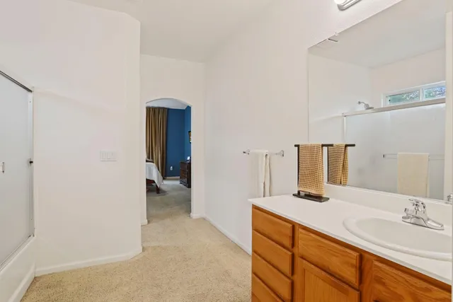 a view of a yard with a table and chairs under an umbrella