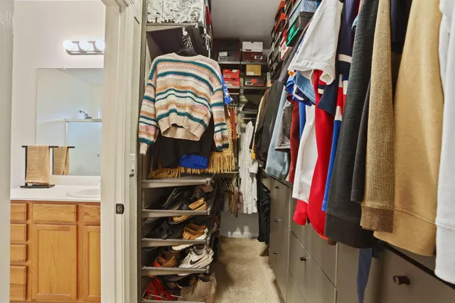 a view of a swimming pool with a table and chairs under an umbrella