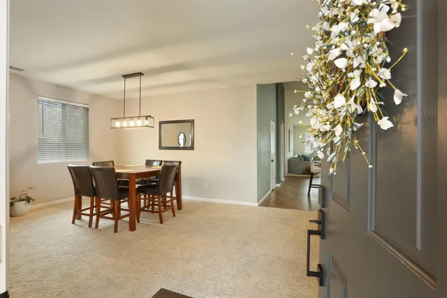 a dining room with furniture a chandelier and window