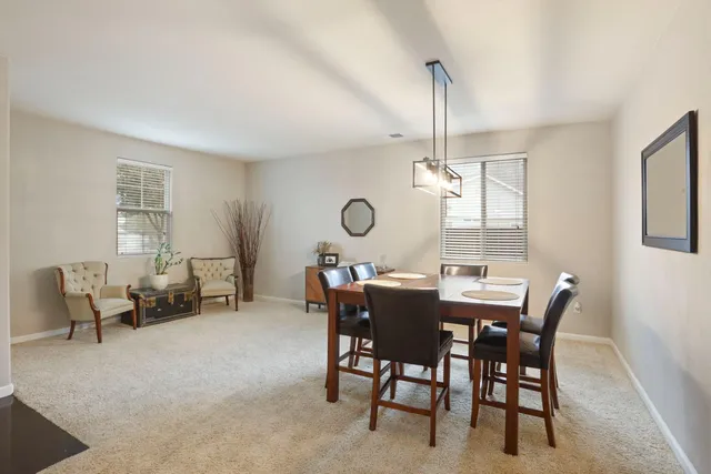a view of a dining room furniture and window