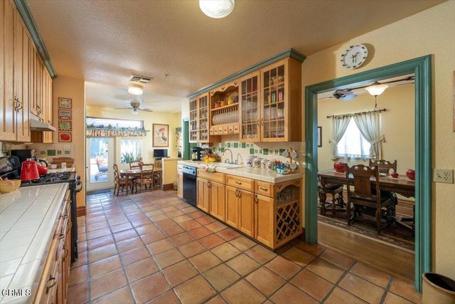 a view of a kitchen with kitchen island dining table and a large window