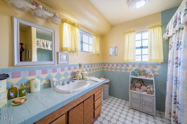 a bathroom with a sink a vanity and a mirror