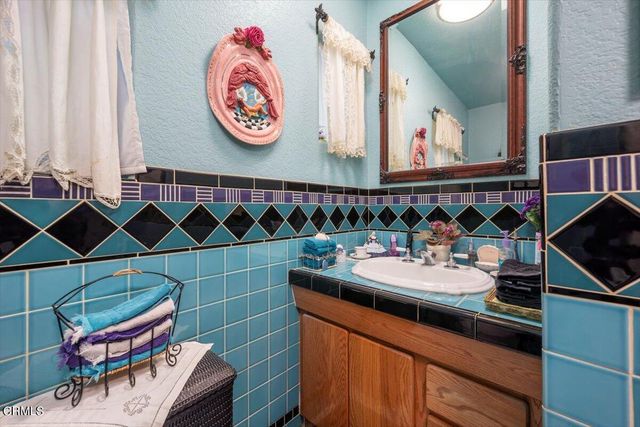 a bedroom with furniture and a flat screen tv