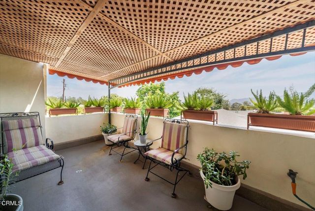 a view of a house with swimming pool and sitting area