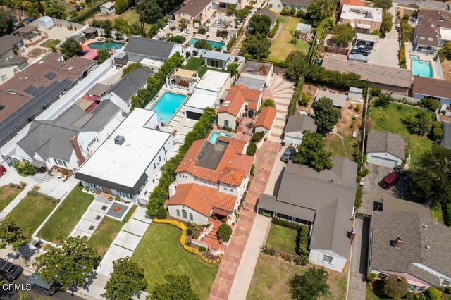 an aerial view of residential houses with outdoor space