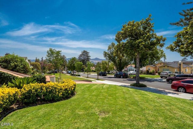 a view of a swimming pool with lawn chairs and a fire pit
