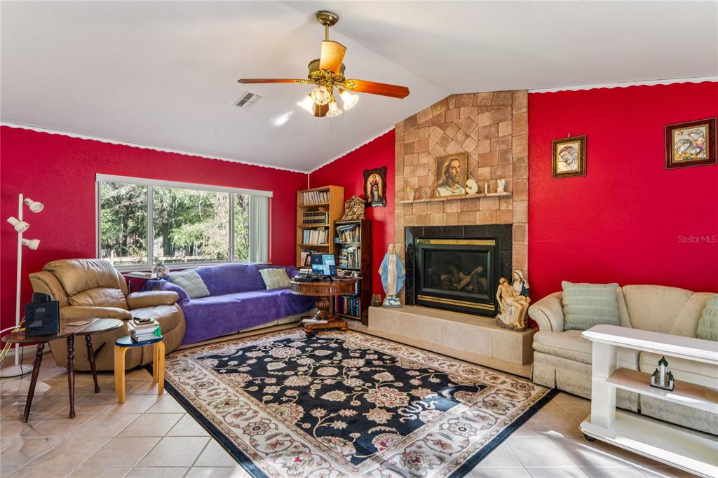 26861 Mondon Hill Road Brooksville, FL 34602 - Photo 14 of 51 a living room with furniture and a fireplace