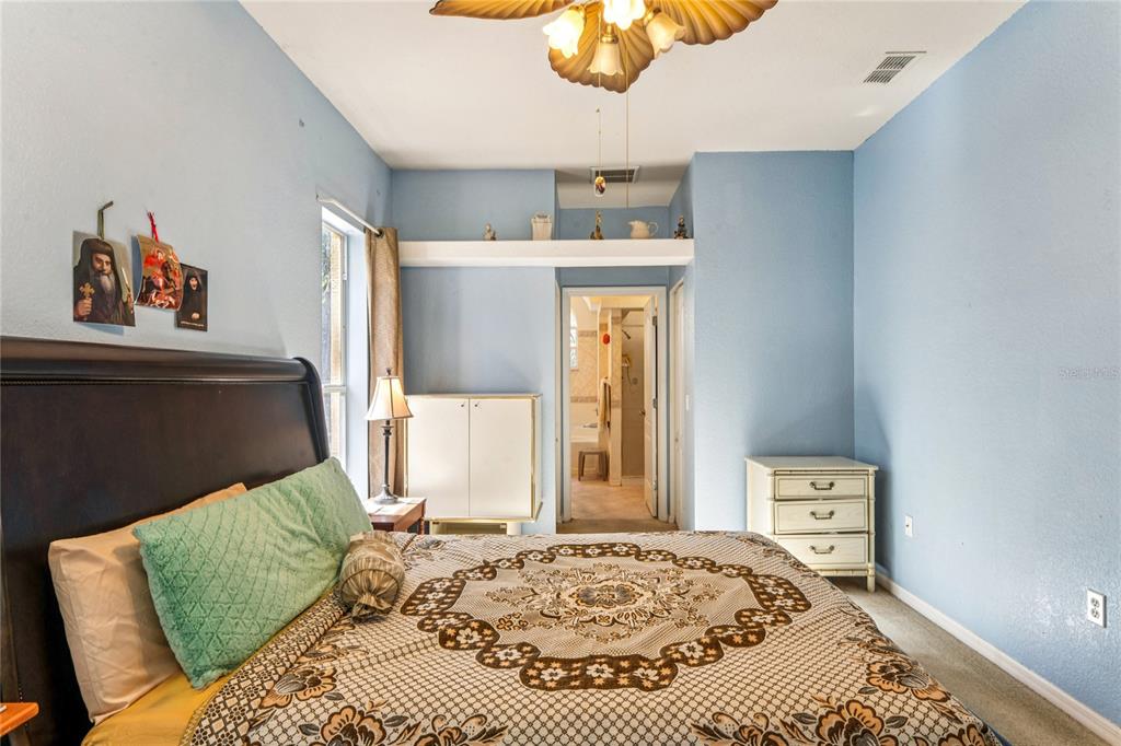 26861 Mondon Hill Road Brooksville, FL 34602 - Photo 18 of 51 a bedroom with a bed and a window