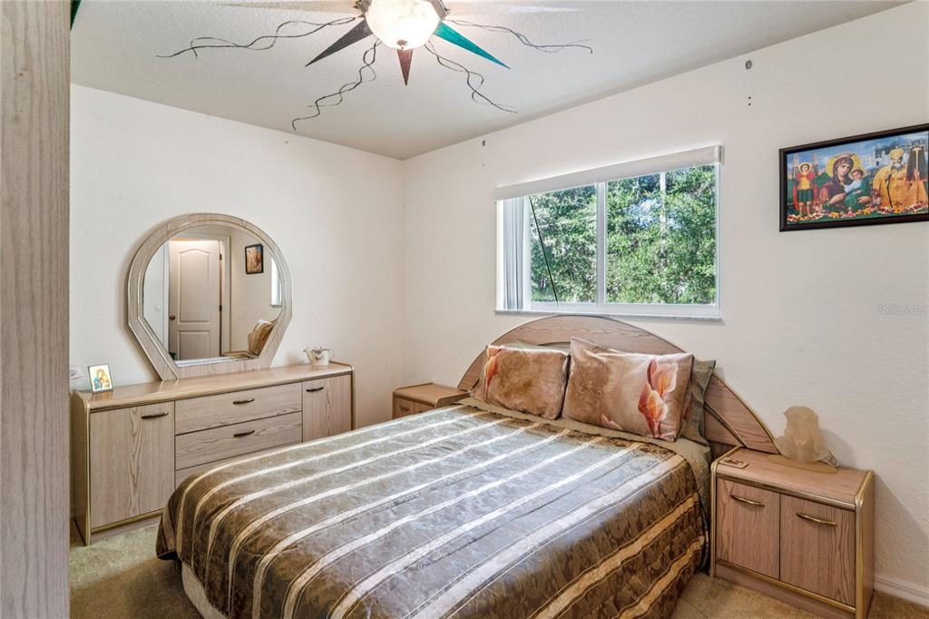 26861 Mondon Hill Road Brooksville, FL 34602 - Photo 23 of 51 a bedroom with a bed and a dresser