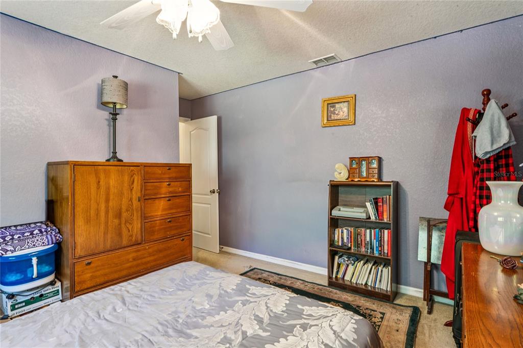 26861 Mondon Hill Road Brooksville, FL 34602 - Photo 28 of 51 a bedroom with furniture and a window