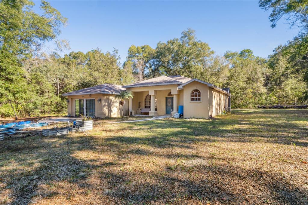 26861 Mondon Hill Road Brooksville, FL 34602 - Photo 49 of 51 a front view of a house with a garden