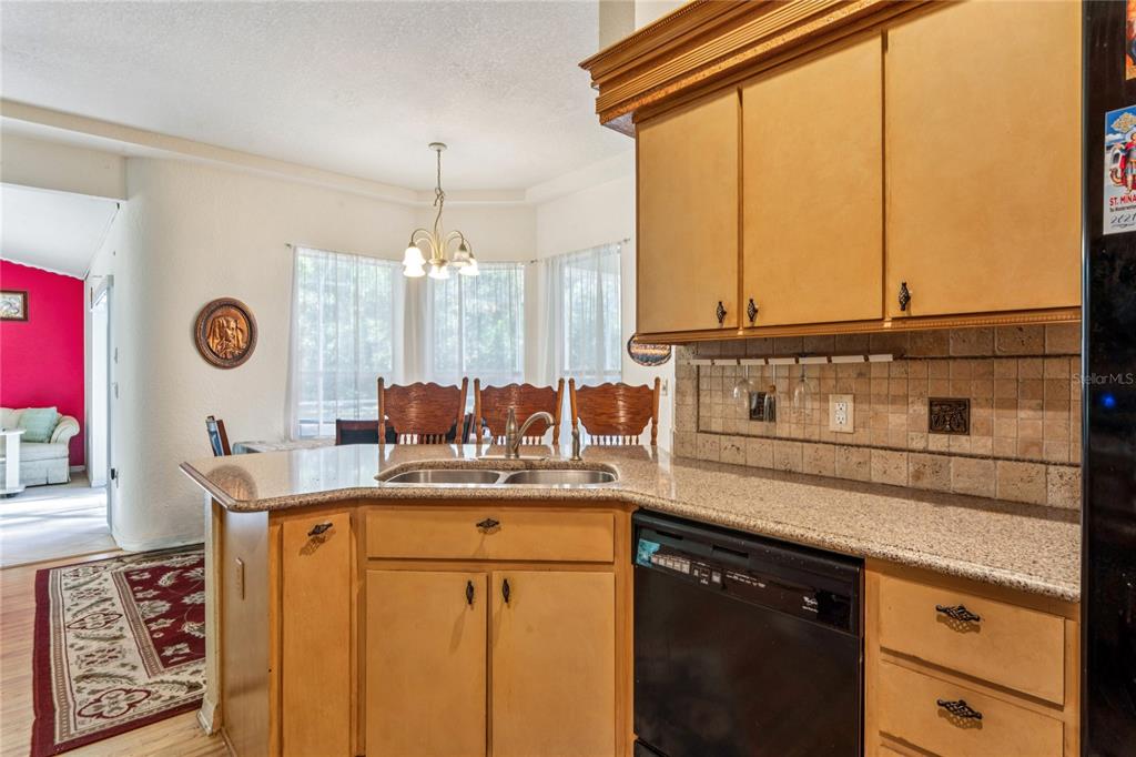 26861 Mondon Hill Road Brooksville, FL 34602 - Photo 8 of 51 a kitchen with a sink a cabinets and window