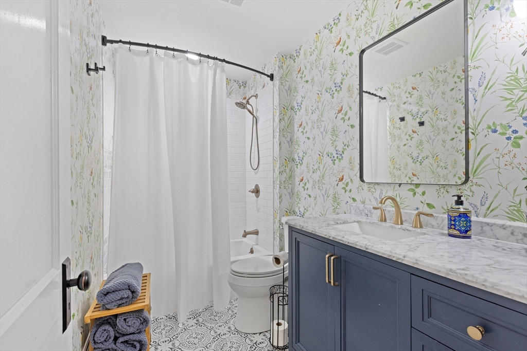 20 St Elmo Road Worcester, MA 01602 - Photo 30 of 40 a bathroom with a granite countertop sink a toilet and a shower