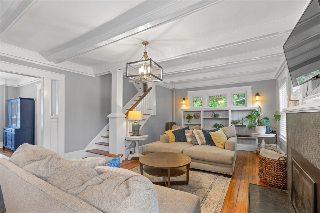 20 St Elmo Road Worcester, MA 01602 - Photo 6 of 40 a living room with furniture a fireplace and a chandelier