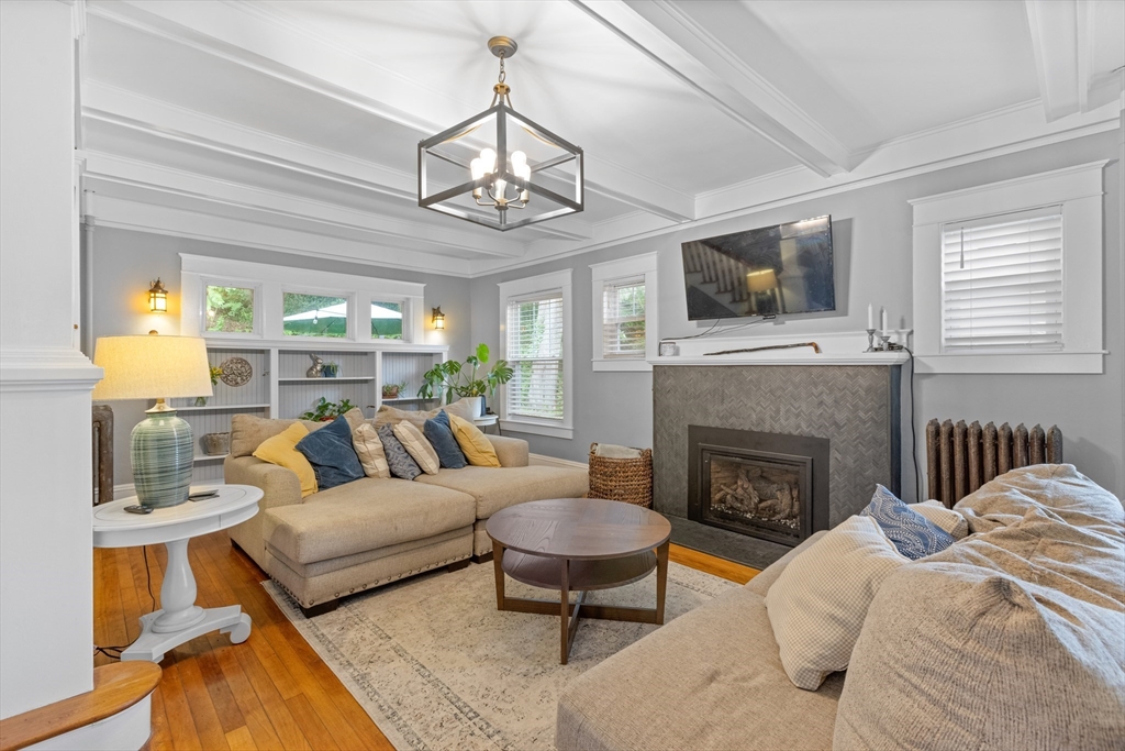 20 St Elmo Road Worcester, MA 01602 - Photo 7 of 40 a living room with furniture a flat screen tv and a fireplace