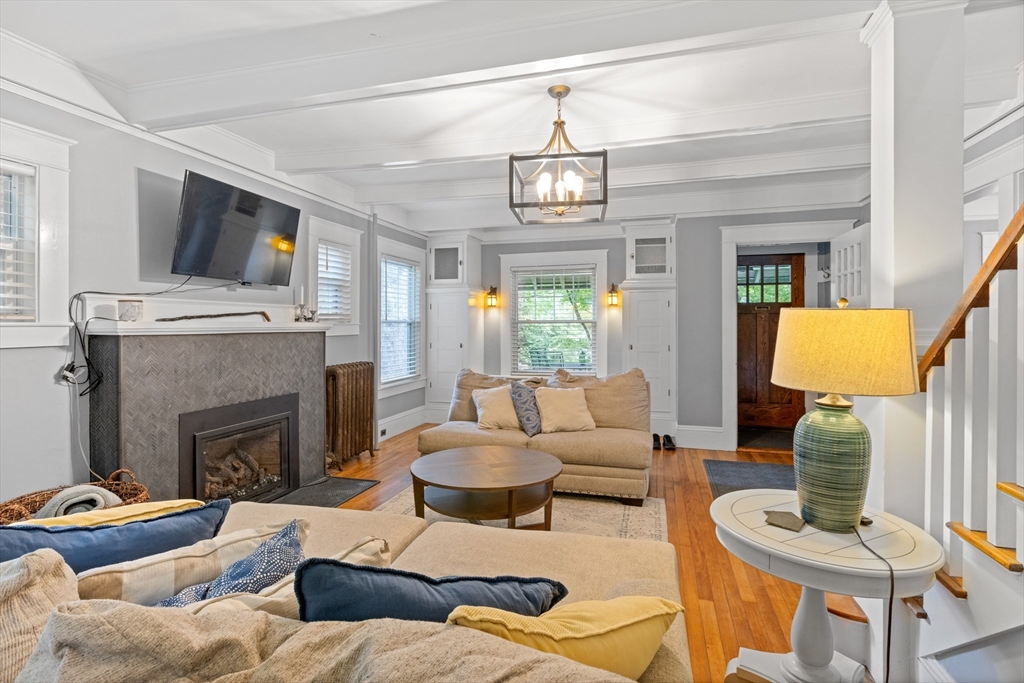 20 St Elmo Road Worcester, MA 01602 - Photo 9 of 40 a living room with furniture a fireplace and a chandelier