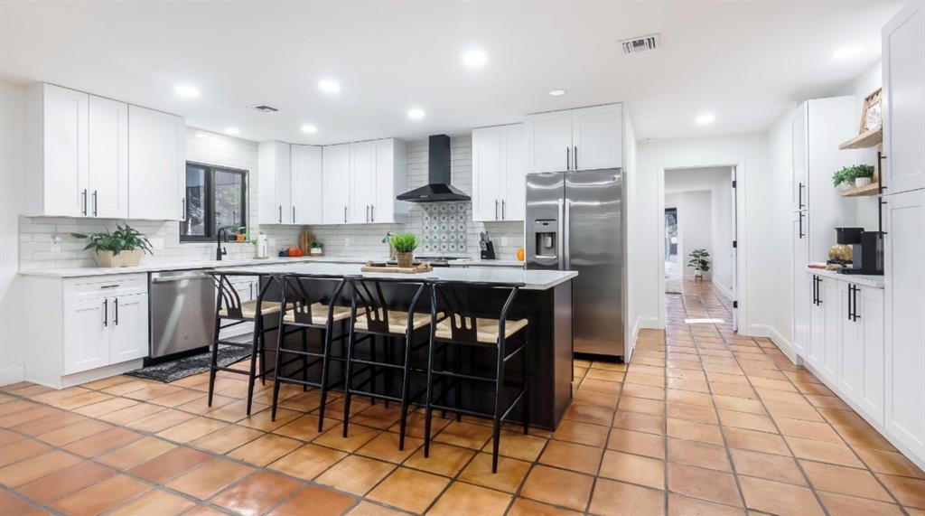 17191 38th Road North Loxahatchee, FL 33470 - Photo 12 of 60 a kitchen with stainless steel appliances kitchen island granite countertop a dining table chairs and sink