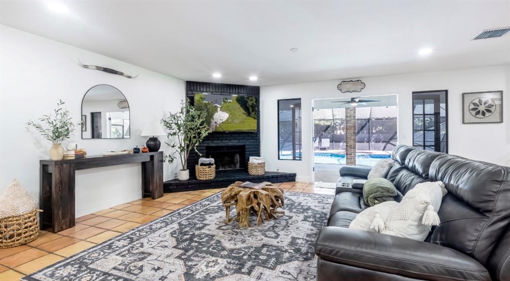 17191 38th Road North Loxahatchee, FL 33470 - Photo 15 of 60 a living room with furniture a fireplace a rug and a window