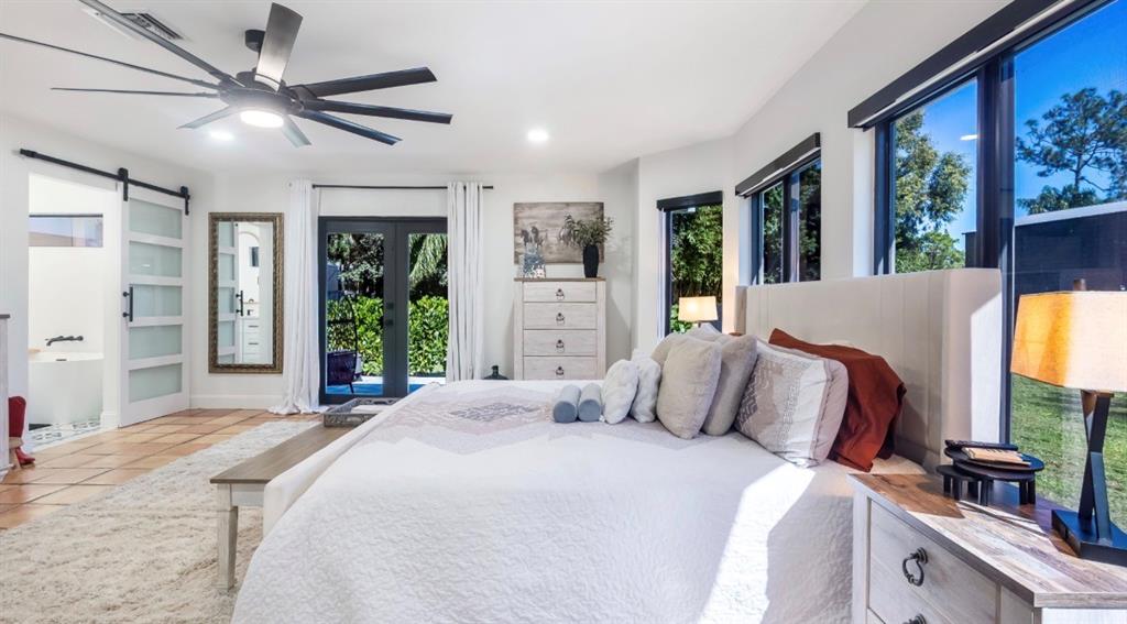 17191 38th Road North Loxahatchee, FL 33470 - Photo 20 of 60 a bedroom with a large bed and a large window