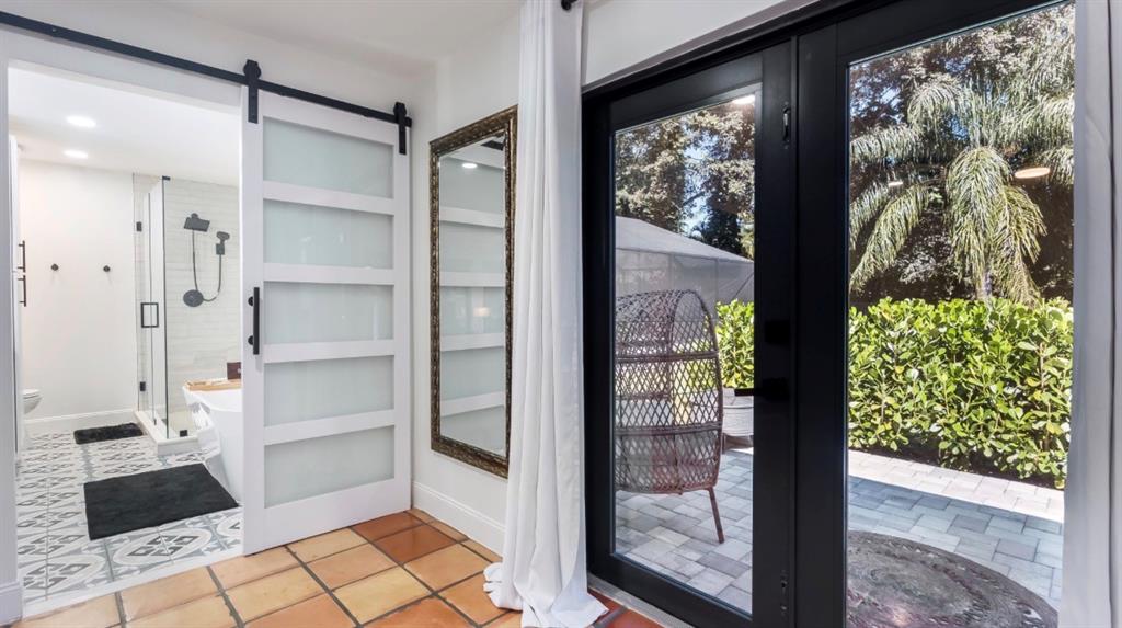 17191 38th Road North Loxahatchee, FL 33470 - Photo 22 of 60 a bathroom with a glass shower door and a wooden floor