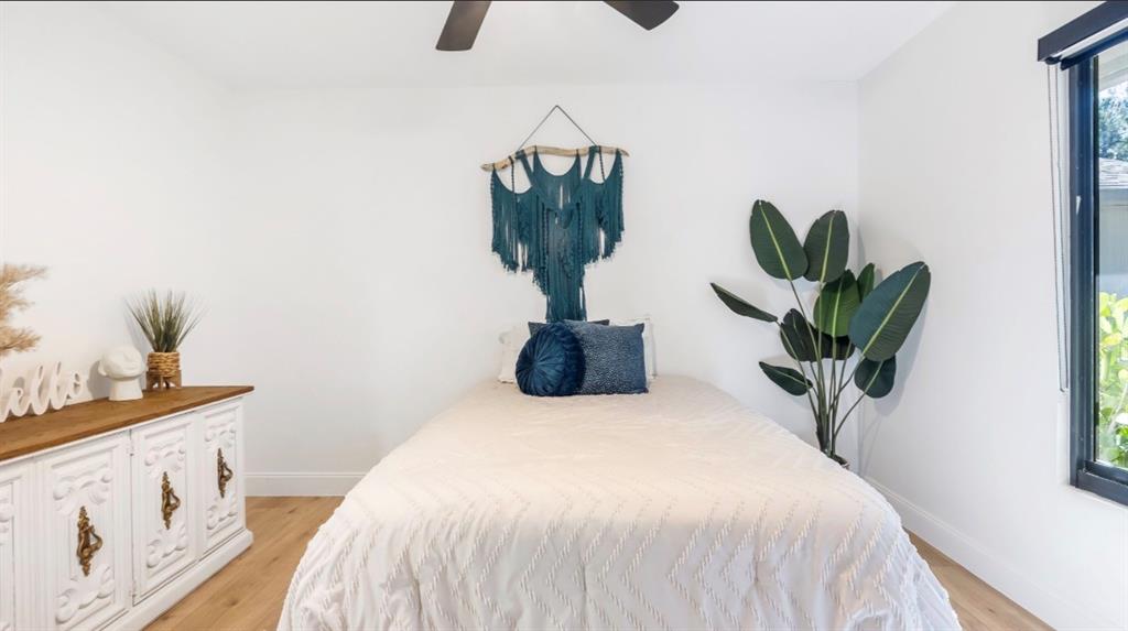 17191 38th Road North Loxahatchee, FL 33470 - Photo 30 of 60 a bedroom with a bed and a potted plant